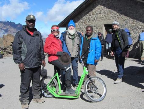 An der Kibo-Hütte prästentiert Franz Zehendmaier den Rettungs-Roller dem Leiter der Bergwacht und dem Chef der Klimadjaro Parkgesellschaft